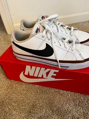 Nike White Sneakers with Black Swoosh and Brown Trim, very little wear.